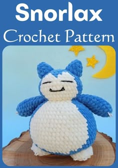 a crocheted stuffed animal sitting on top of a tree stump with the caption snorlax crochet pattern