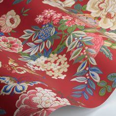 an image of a red floral wallpaper with blue and pink flowers on the side