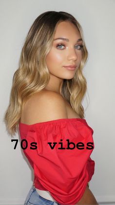 a woman with blonde hair and blue eyes is wearing a red top that says 70's vibes