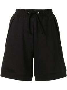 Black cotton relaxed track shorts from 3.1 PHILLIP LIM featuring elasticated waistband, drawstring fastening and two side zip-fastening pockets. | 3.1 Phillip Lim Relaxed Track Shorts Black Lounge Shorts With Side Pockets, Sporty High-waisted Bermuda Shorts With Elastic Waistband, Sporty Bermuda Athletic Shorts For Loungewear, Sporty Knee-length Loungewear Shorts, Sporty Bermuda Shorts With Elastic Waistband, Sporty Bermuda Shorts With Pockets, Sporty Relaxed Fit Cargo Shorts, Sporty Black Cotton Bermuda Shorts, Sporty Relaxed Fit Bermuda Shorts For Streetwear