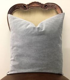 the back of a chair with a pillow on it