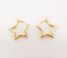 pair of gold star earrings on white background