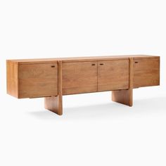 the sideboard is made from wood and has three drawers on one end, and two doors on the other