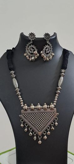 This is an elegant and unique thread necklace with traditional silver pendant. Its simplicity and elegance will add to the style statement. Oxide Jewellery, Black Thread Necklace, Diy Earrings Materials, Oxidised Jewelry, Country Necklace, Traditional Pendant, Flower Jewelry Designs, Bronze Anniversary Gifts, Navratri Collection