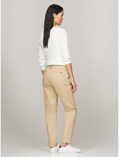 Tommy Hilfiger women's pant. Cut in a slim fit, our chino is made from a stretch cotton blend offering lightweight breathability and comfort.  Material: 77% Better Cotton Initiative, 20% Recycled Cotton, 3% Elastane. Fitted Tommy Hilfiger Bottoms For Fall, Tommy Hilfiger Fitted Bottoms For Fall, Classic Slim Fit Mid-rise Chinos, Mid-rise Chinos For Business Casual, Slim Fit Mid-rise Chinos For Work, Slim Fit Mid-rise Classic Chinos, Classic Mid-rise Chinos For Business Casual, Tommy Hilfiger Casual Bottoms For Fall, Tommy Hilfiger Casual Fall Bottoms