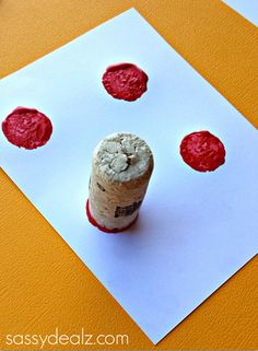 a cork with red wax on it sitting on top of a piece of paper