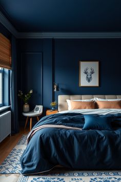 a bedroom with dark blue walls and wood flooring is pictured in this image, the bed has two pillows on it