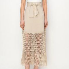 Stunning Fringe Hem High Waist Skirt - This Skirt Boasts A Unique Fringed Hem And High Waist Design, Accentuated By A Chic Belt. Elevate Your Style With This Fashionable Piece Today! Beige Midi Skirt For Party, Party Beige Midi Skirt, Beige Pleated Skirt For Beach, Beige Tiered Mini Skirt For Beach, Spring Beach Skirt In Beige, Beige Beach Skirt For Spring, Elegant Fringe Mini Skirt For Spring, Elegant Spring Fringe Mini Skirt, Spring Beige Pencil Mini Skirt