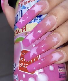 a woman's hand with pink manicures and stars on it