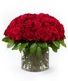 a vase filled with red roses on top of a table