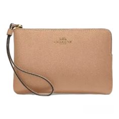 This Beautiful Coach Wristlet Is Perfect For Any Occasion. Crafted From High-Quality Leather, This Wristlet Features A Stylish Gold/Taupe Color With A Solid Pattern And Metal Accents. The Convenient Corner Zip Design Provides Easy Access To Your Credit Cards And Other Essentials While On The Go. With Its Compact Size And Versatile Style, This Wristlet Is A Must-Have Accessory For Any Fashion-Forward Woman. Whether You're Running Errands Or Hitting The Town With Friends, This Coach Wristlet Adds Coach Beige Bag With Zipper Pouch, Coach Clutch For Daily Use, Coach Beige Pouch Wristlet, Beige Coach Pouch Wristlet, Coach Clutch With Zipper Pouch, Coach Wristlet Pouch For Daily Use, Coach Wristlet With Removable Pouch For Daily Use, Everyday Coach Clutch With Zipper Pouch, Elegant Beige Coach Wristlet