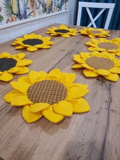 sunflowers are laid out on the table to be made into wall hangings