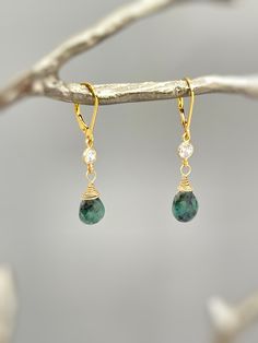 Genuine Emerald Earrings. Dainty handmade crystal dangle tear drop earrings.  Dainty raw emerald gemstone tear drops are wire wrapped in 14k gold fill or sterling silver and hang from sparkling bezel set crystals. Matching French hook or leverback earring backs available. Gemstone drops are dainty approx 8x9mm. Simple, elegant everyday earrings. Lightweight elegant earrings.  Emeralds are organic in nature and contain some color variations and inclusions. Please see photo for some examples. Emer Elegant Adjustable Wire Wrapped Teardrop Earrings, Bohemian Gemstone Teardrop Earrings, Adjustable Drop Earrings With Natural Stones, Everyday Teardrop Gemstone Jewelry, May Birthstone Gemstone Teardrop Pendant, Teardrop Pendant With May Birthstone Gemstone, Fine Jewelry Teardrop Earrings For Everyday, Emerald Drop Earrings As A Gift, Emerald Drop Earrings Gift