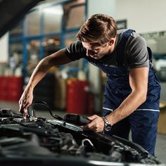 a man working on an engine in a garage