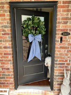 The signature bow wreath sash in blue and white gingham is an instant classic! Crisp cotton in a 1/4” check is a lovely combination with almost any wreath. • Please note that this listing is for one wreath bow sash, wreath not included. • Available in two sizes: standard 70” long by 6” wide laid flat, or jumbow 90” long by 8” wide. All sashes come pre-wired into a bow and wreath ready, no bow tying skills required! • The large size is 16” x 25” when tied in a bow, the standard size is 13”x21”• • Wreaths For Front Door With Bow, Wreath With Monogram Sash, Spring Time Wreaths Front Doors, Gingham Home Decor, Wreath Sash Front Door, Front Door Ideas Apartment, Door Decorations Apartment, Wreath With Sash, Sash For Wreath