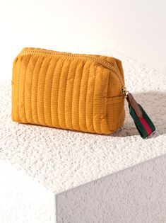 Perfect your on-the-go lifestyle with Ezra Small Boxy Cosmetic Pouch. This pouch features a sleek quilted body, and a boxy silhouette, perfectly pairing with Ezra Totes. Measuring L 7" × W 3" × H 4", and made from nylon, the Ezra Small Pouch is equipped with an inner zip and slip pocket, maximizing the space this pouch provides. This pouch is perfect for storing your makeup, toiletries or any odds and ends that you may need during travel or on a daily basis. Pair with other items from to complete your look! L 7" × W 3" × H 4"NylonTop Zip ClosureInner Zip Pocket, Inner Slip PocketVegan *CALL US TO ADD CUSTOMIZATION 270-761-2449*1 LETTER: +$42 LETTERS: +$83 LETTERS: +$12 Honey Cosmetics, Heeled Mules Sandals, Odds And Ends, Small Pouch, Shoe Gifts, Small Pouches, Makeup Bags Travel, Cosmetic Pouch, Travel Makeup