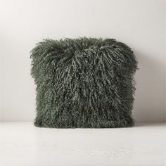 a green pillow sitting on top of a white counter