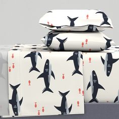 three sheets with sharks on them are stacked next to each other