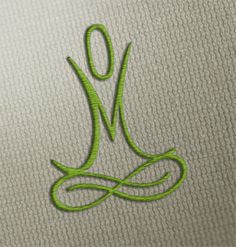 the letter j is made up of green thread on a white surface with a black outline