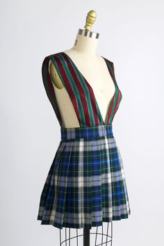 Pleated apron dress in deadstock lurex stripe fabric on the straps and short tartan skirt. Zip closure with button on side of skirt. Worn with the Erin Top and Erin Pant in Blue Check. 51% Cotton, 49% Polyester. Made in NYC. Full length: 29.5" Skirt length: 16" Waist: 27" Exclusive to Batsheva. Reworking Clothes, Fair Outfit, Tokyo Trip, Pattern Clothes, Fair Outfits, Nyc Model, Tartan Skirt, 2024 Style, Bubble Skirt