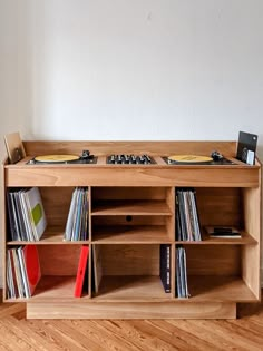 an entertainment center with record players and records