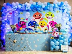 a baby shark themed birthday party with balloons