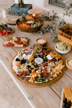 a wooden table topped with lots of different types of food