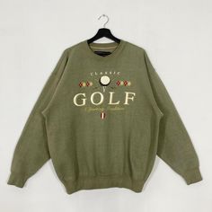 a green sweatshirt with the words golf on it