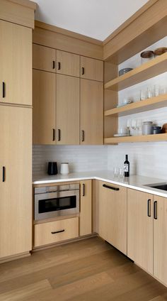 a kitchen with wooden cabinets and white counter tops