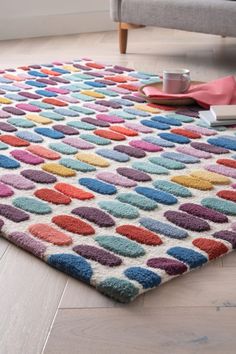 a multicolored rug on the floor in a living room