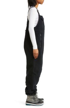 Hit the slopes in these fluffy fleece overalls designed with functional straps and secure pockets. 50" center front length; 29" inseam; 12" leg opening (size Large) Adjustable buckle straps Square neck Bib flap hook-and-loop pocket; front zip pockets; back zip pocket Elastic cuffs Partially lined 100% polyester Machine wash, tumble dry By Free People; imported Fleece Overalls, Free People Hit The Slopes, Fp Movement, Snow Pants, Bibs, Square Neck, Zip Pockets, Overalls, Free People