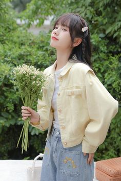 Cropped denim jacket in a light yellow with slightly accentuated shoulders and ruched pocket slits. S: 16.5" across shoulders, 40" chest, 19" lengthM: 17" across shoulders, 41.5" chest, 19" lengthL: 17.5" across shoulders, 43" chest, 19" length Spring Denim Jacket With Button Closure, Beige Long Sleeve Denim Jacket For Spring, Yellow Cotton Denim Jacket For Fall, Trendy Beige Denim Jacket For Spring, Yellow Cotton Denim Jacket With Pockets, Beige Button-up Denim Jacket For Spring, Yellow Denim Jacket With Pockets For Fall, Yellow Spring Outerwear With Pockets, Spring Yellow Outerwear With Pockets