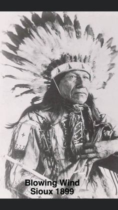 an old black and white photo of a native american man with feathers on his head