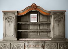 an old wooden cabinet with ornate carvings on the doors