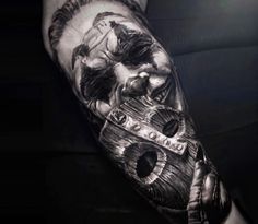 a man's arm with a tattoo on it that has an image of a person holding