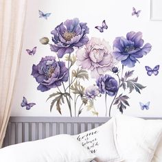 purple flowers and butterflies are painted on the wall