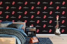 a bed room with a guitar and a wallpaper that has the rolling stones on it