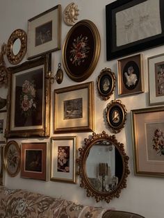 there are many framed pictures on the wall