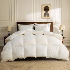 a white comforter on a bed in a room