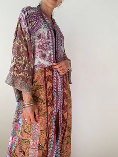 "This is one of a kind patchwork, upcycled silky robe Made free size with wrap tie closing and wide kimono sleeves Easy and fun to wear around the house or outside as a urban boho style, flowy kardigan with jeans and tshirt It is very comfy and feels soft and light the material is silky and flowy made into this unique stylish over all MEAESURE free size length 55\" MATERIAL *polyester * no lining more available at https://www.etsy.com/uk/shop/Gyaki? CARE INSTRUCTIONS * Wash in warm water * Hand Silk Long Kimono For Beach Cover-up, Bohemian Long Patchwork Kimono, Multicolor Long Kimono With Boho Print, Long Multicolor Boho Kimono, Multicolor Silk Kimono For Beach Cover-up, Multicolor Long Robe For Beach Cover-up, Bohemian Multicolor Patchwork Kimono, Multicolor Long Robe For Beach, Long Patchwork Kimono For Festivals