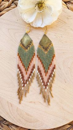 ♀ Bohemian Native American-inspired beaded earrings handmade with glass beads, sandstone, and brass.  ♀ Drop Length: 6 in. ♀ Beads: Toho, Miyuki, Czech ♀ Ear wire: 18k gold-plated brass ♀ Thread: Nylon ♀ Made to order, ships within 2-3 weeks. Get 20% Off! Click on the link below and enter ETSY20 during checkout: https://moonandmilk.com/products/sade-green-pink-sunstone-beaded-earrings?_pos=2&_sid=4321abc20&_ss=r Multicolor Beaded Brass Earrings, Earthy Beaded Dangle Jewelry, Beaded Dangle Earrings In Brass, Beaded Brass Earrings For Festival, Bohemian Long Drop Jewelry With Tiny Beads, Handmade Bohemian Brass Beads, Brass Beaded Earrings With Round Beads For Festival, Multicolor Dangling Beaded Brass Earrings, Gold Bohemian Beaded Earrings With Faceted Beads