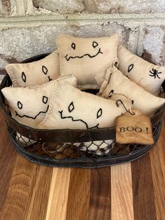 several pillows in a basket on a wooden floor