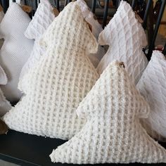 several white pillows stacked on top of each other