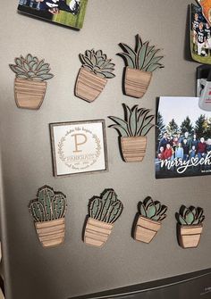 a refrigerator covered in magnets with plants and pictures on the front, along with other magnets