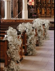 rows of pews with white flowers in them