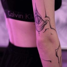 a woman with a tattoo on her arm