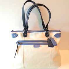 Coach Daisy Spectator Emma Genuine Leather Cream, Navy And Medium Blue Tote With Double Handles And Zip Closure. Cream Satin Dust Cover Included! Details: Smooth Genuine Leather Cream Body Navy And Medium Blue Trim Zip-Top Closure Front: Zip Pocket Back: Open Pocket Inside: Navy Satin Lining / 1 Zip And 2 Multifunction Pockets Approx. Dimensions: 16" (W) X 12.5" (H) X 4" (D) Handle Drop 8.5" Excellent Condition, Never Worn Nwot Smoke-Fee Home Same Or Next Day Shipping Coach Cream Bags With Removable Pouch, Coach Bags With Removable Pouch In Cream, Coach Cream Shoulder Bag For Daily Use, Coach Cream Bag With Detachable Handle, Coach Cream Satchel Bag, Coach Cream Shoulder Bag For Travel, Coach Cream Double Handle Bag, Coach Cream Tote Shoulder Bag, Coach Beige Shoulder Bag For Office