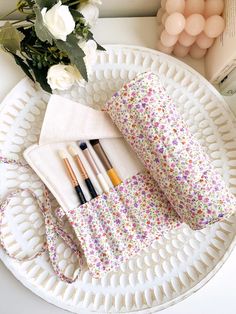 Our floral quilted makeup brush roll is handmade in Melbourne in a cotton fabric. It offers style and keeps your makeup brushes protected during travel.  Featuring 12 spacious pockets and a long tie to help secure your brushes in place. It is perfect for travel and everyday use. Dimensions of product lay flat  20cm height x 37cm width, tie 64cm long Care instructions Hand wash recommended or machine cold wash on gentle cycle in wash bag Makeup Brush Roll, Floral Makeup, Brush Roll, Makeup Brush Holder, Makeup Brush Holders, Toiletry Storage, Design Floral, Wash Bags, Makeup Brush