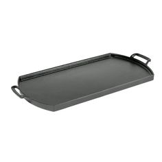 an empty cast iron roasting pan on a white background