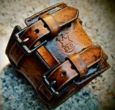 "This leather cuff uses fine natural vegetable tanned leather that I hand dye in a destroyed brown finish. It contains a splattering of red, black and dark brown dyes with a few inkwell stains and handstitched edges! It has 2 straps woven through the leather and a small center strap attached with hand aged rivets. 2 hand aged roller buckles provide the closure. I need your wrist size for this special cuff! Please use the Instructions in the pics above! - 3\" wide - destroyed dye finish - Vegetab Black Leather Cuff Bracelet, Mens Leather Accessories, Brown Leather Bracelet, Leather Cuff Bracelet, Leather Wristbands, Mens Leather Bracelet, Leather Cuffs Bracelet, Leather Projects, Leather Cuffs